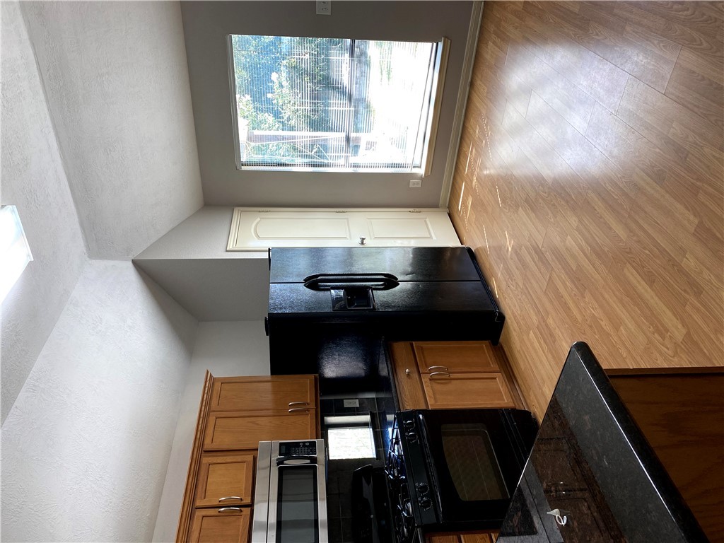 2018 Snowy Brook Trail Bryan, TX 77807 - Photo 2 of 9 a kitchen with granite countertop a refrigerator stove and microwave