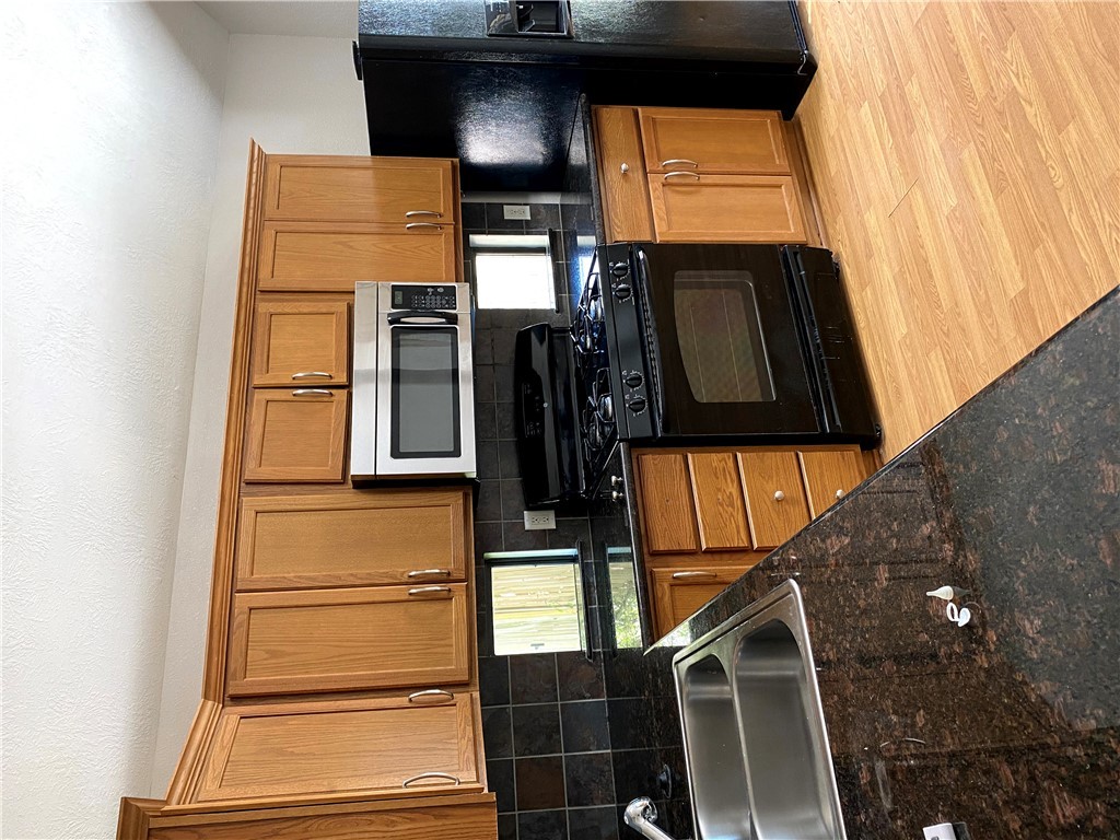 2018 Snowy Brook Trail Bryan, TX 77807 - Photo 3 of 9 a kitchen with granite countertop a sink a stove and refrigerator