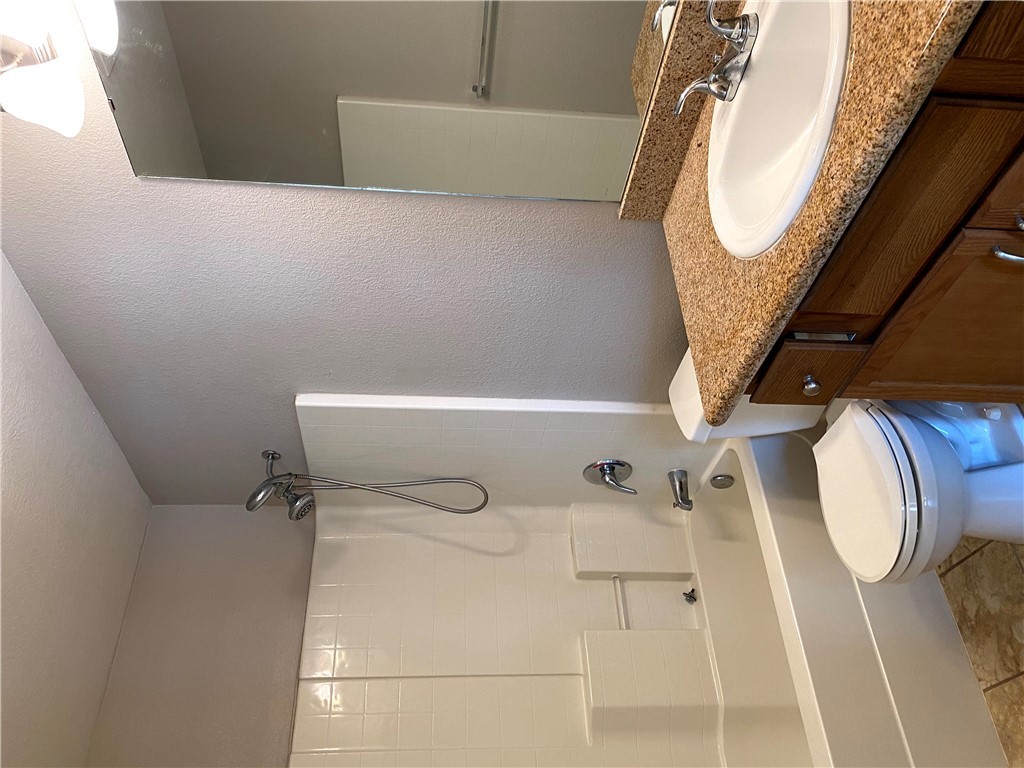 2018 Snowy Brook Trail Bryan, TX 77807 - Photo 5 of 9 a bathroom with a granite countertop sink a toilet and shower