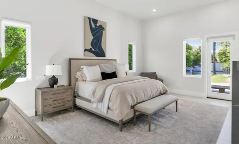 a bedroom with a bed and ceiling fan