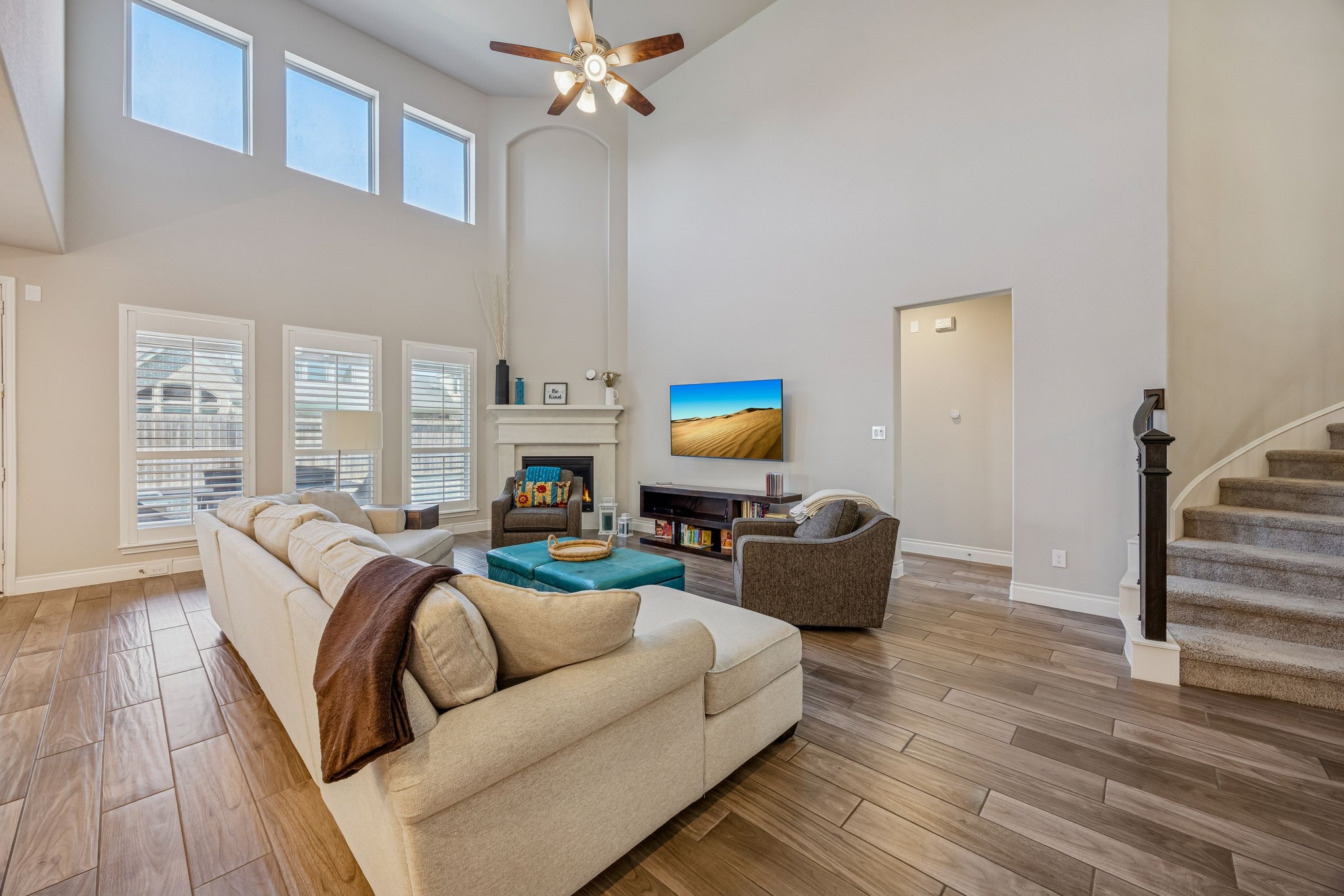 28706 Casen Ranch Lane Fulshear, TX 77441 - Photo 5 of 31 The light-filled family room is anchored by a classic fireplace and features a wall of windows that provide peaceful views of the backyard oasis.