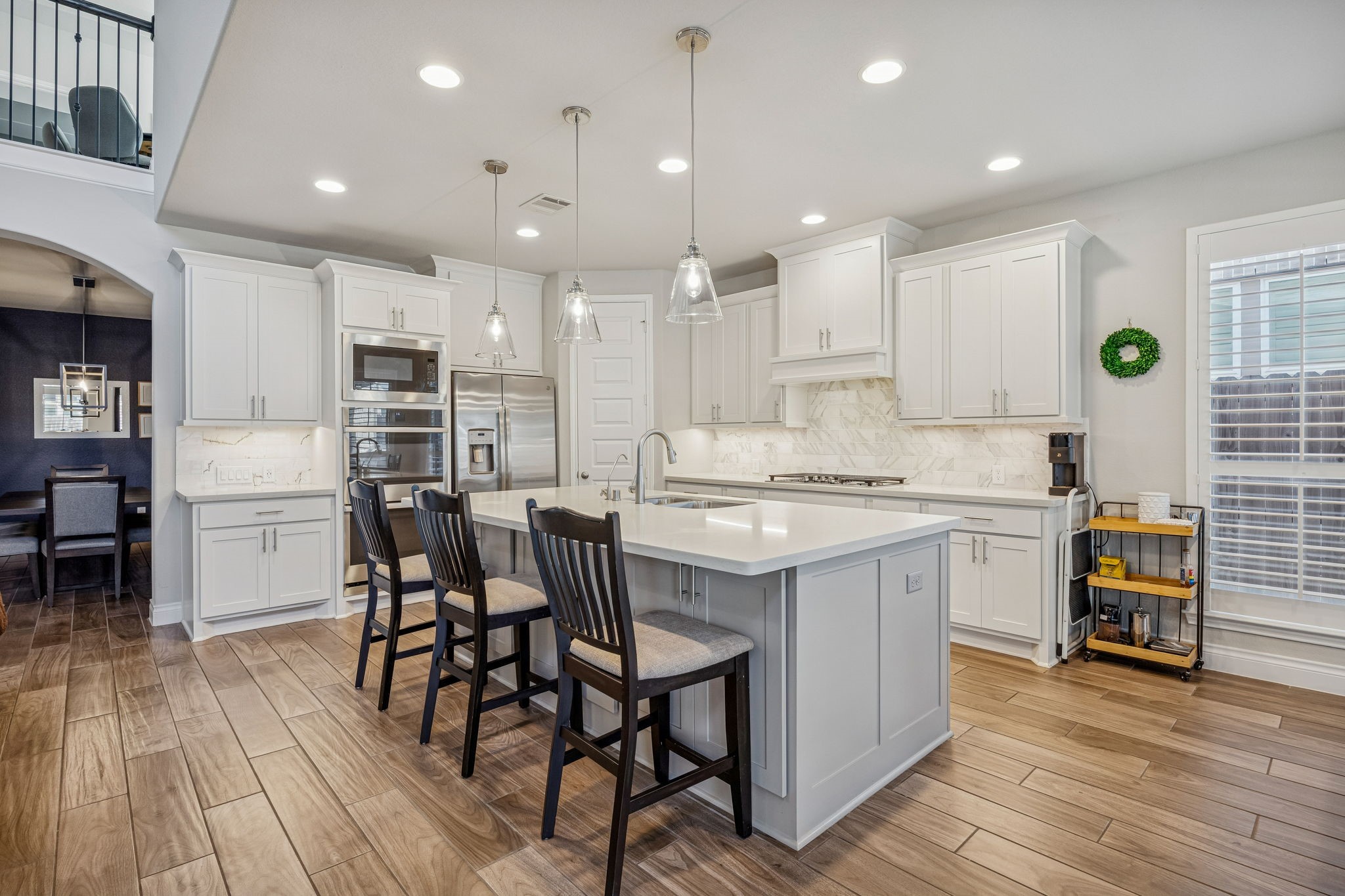 28706 Casen Ranch Lane Fulshear, TX 77441 - Photo 7 of 31 This chef-inspired kitchen features premium Quartz countertops, crisp white cabinetry, and high-end stainless steel appliances, including a double oven and gas range.