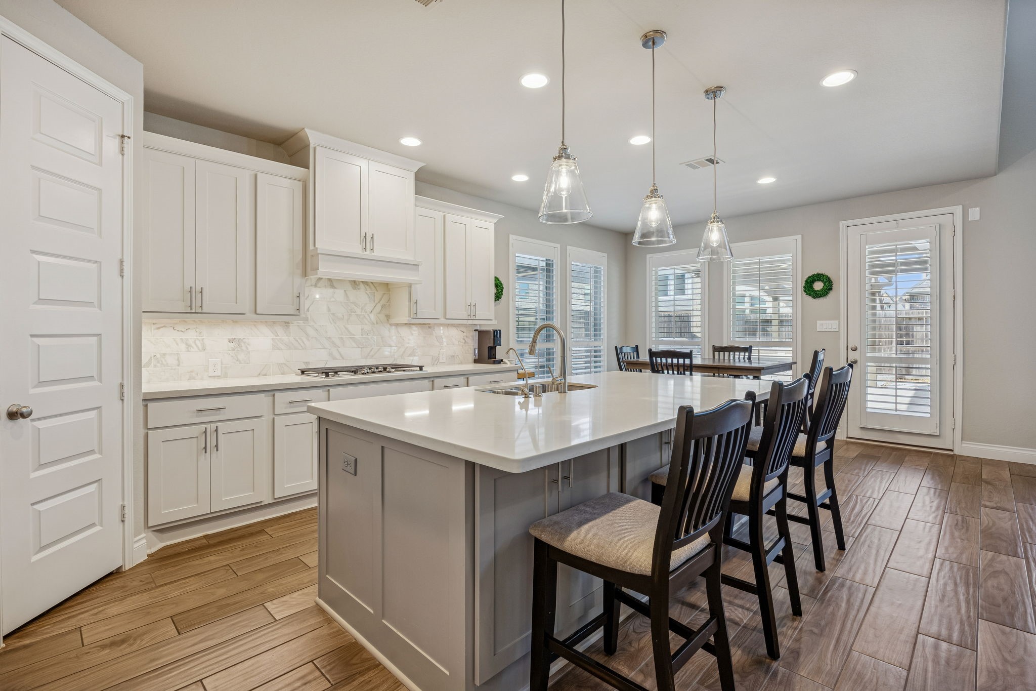 28706 Casen Ranch Lane Fulshear, TX 77441 - Photo 8 of 31 The large central island provides abundant prep space and stylish breakfast bar seating, illuminated by contemporary pendant lighting.