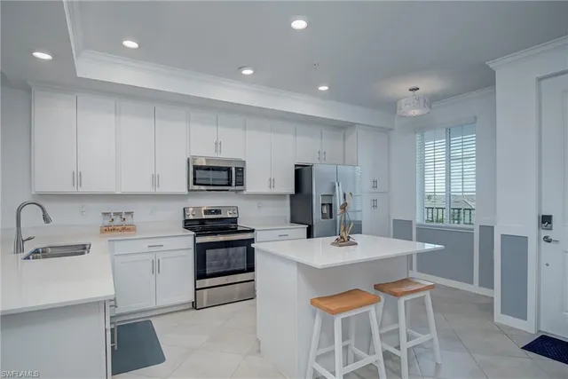 a kitchen with stainless steel appliances a sink stove and refrigerator