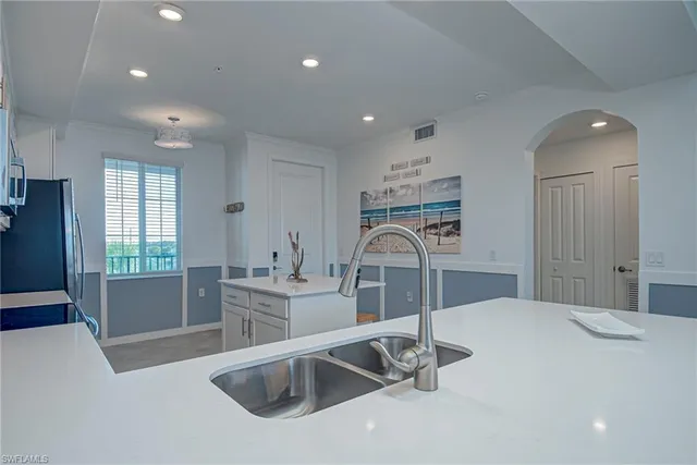 a kitchen with a sink and a refrigerator