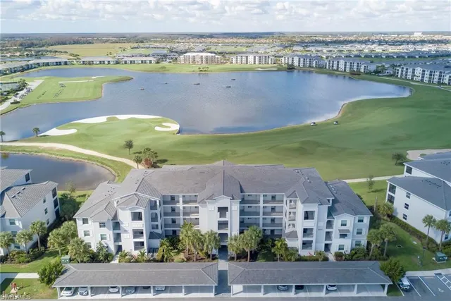 an aerial view of a city with lots of residential buildings and lake view