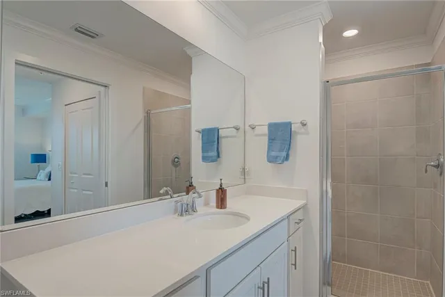 a bathroom with a granite countertop sink a mirror and shower