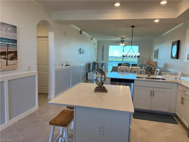 a kitchen with stainless steel appliances kitchen island granite countertop a stove a sink and a refrigerator