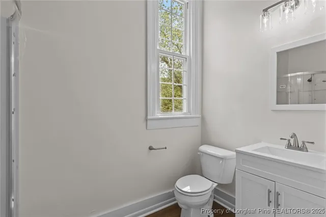 a white toilet sitting next to a bathroom sink