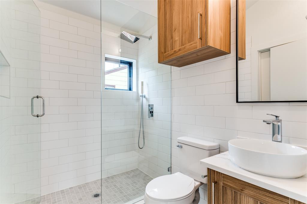 4715 Live Oak Street, Unit 102 Dallas, TX 75204 - Photo 12 of 18 a bathroom with a sink a toilet and shower