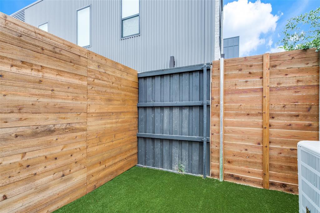 4715 Live Oak Street, Unit 102 Dallas, TX 75204 - Photo 2 of 18 a view of a wooden wall with wooden fence