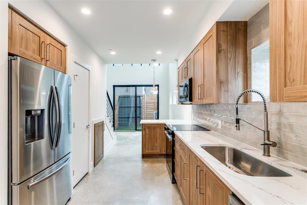 4715 Live Oak Street, Unit 102 Dallas, TX 75204 - Photo 6 of 18 a kitchen with stainless steel appliances granite countertop a refrigerator a sink a stove and a refrigerator with wooden floor