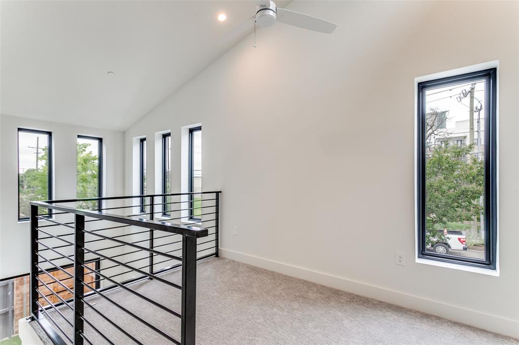 4715 Live Oak Street, Unit 102 Dallas, TX 75204 - Photo 8 of 18 a view of a room with wooden floor and windows
