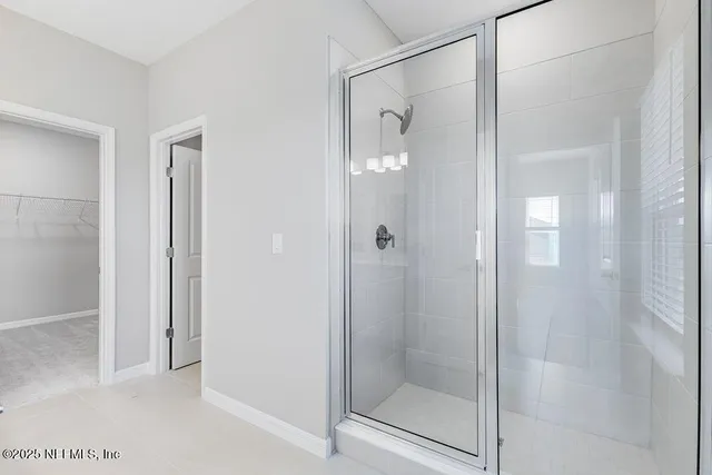 a bathroom with a glass shower door