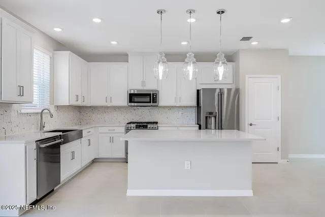 a large kitchen with stainless steel appliances