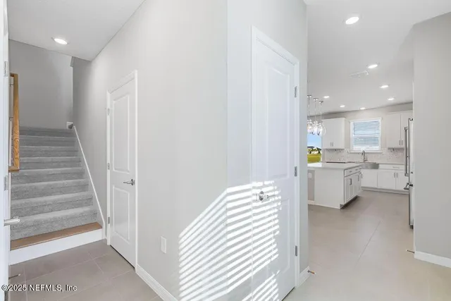 a view of kitchen with sink and refrigerator