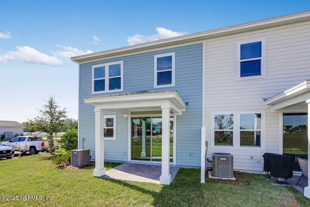 a view of a house with a yard and sitting area