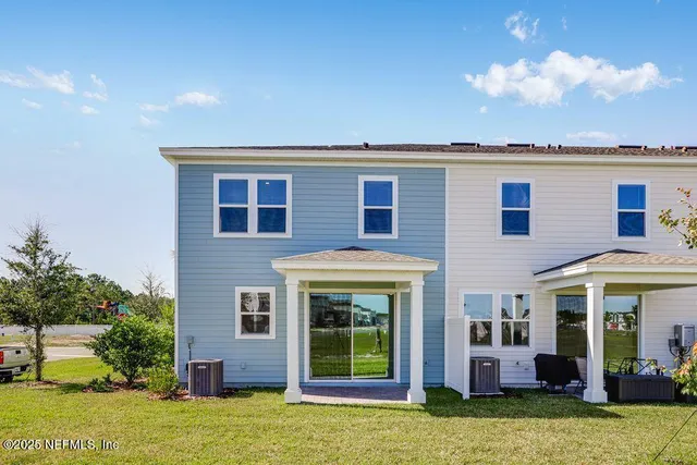 a view of a house with backyard porch and sitting area