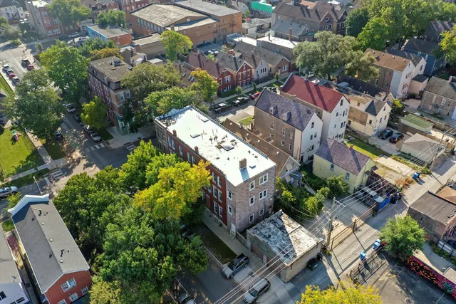 an aerial view of residential houses with yard