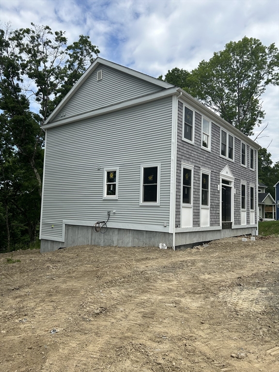 32 Brookside Avenue Webster, MA 01570 - Photo 2 of 12 a front view of a house with a garden