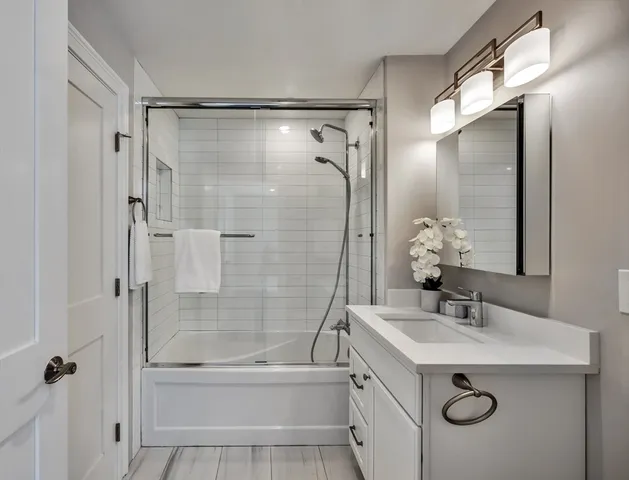 a bathroom with a sink mirror toilet and bathtub