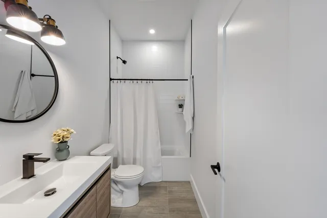 a bathroom with a sink toilet and shower