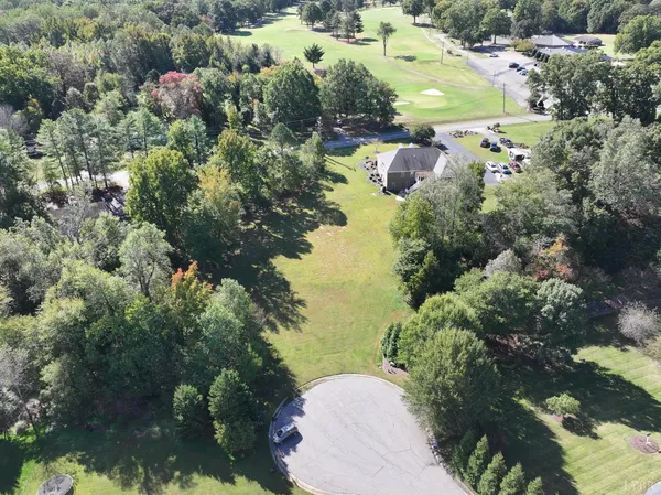 an aerial view of lake residential house with outdoor space and trees around