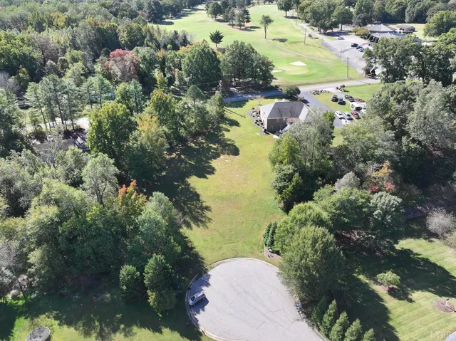 an aerial view of lake residential house with outdoor space and trees around