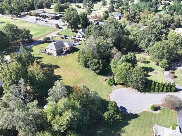 an aerial view of a house with yard