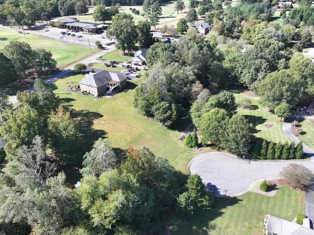 an aerial view of a house with yard