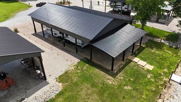 a backyard of a house with table and chairs
