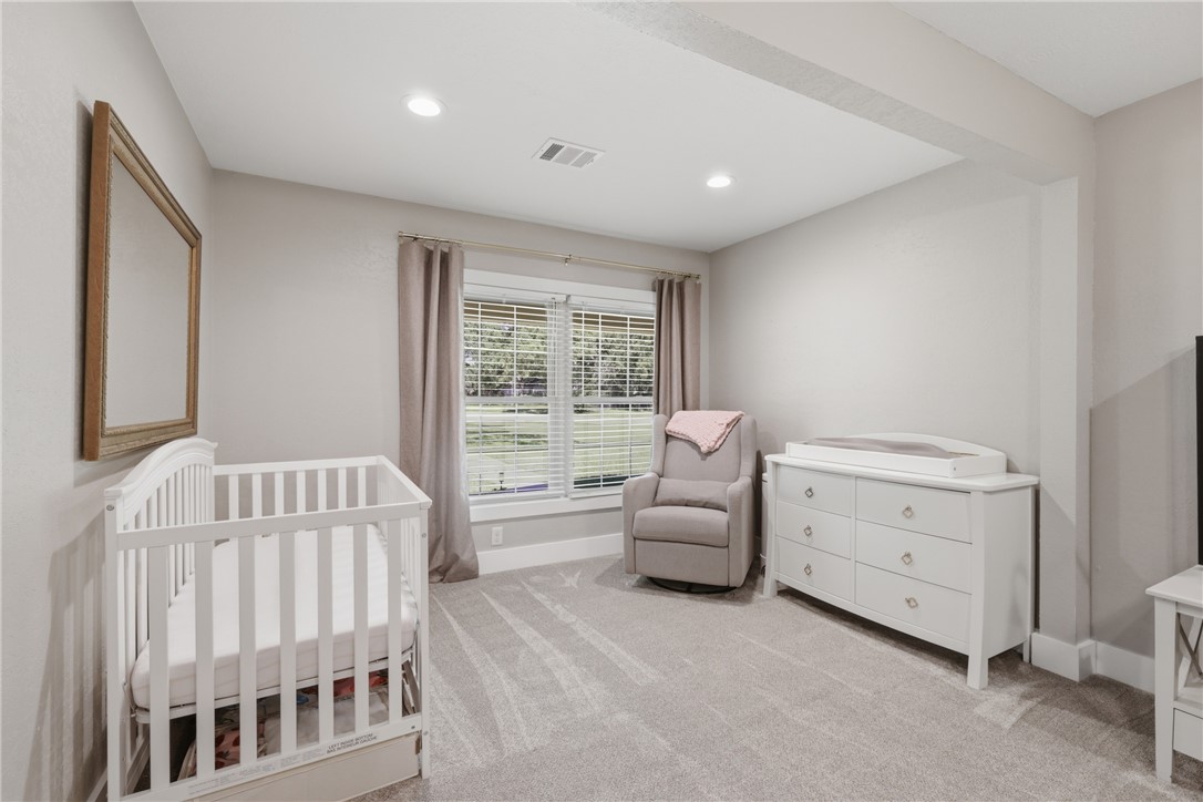 515 Crescent Drive Bryan, TX 77801 - Photo 19 of 43 Carpeted primary room featuring a window with blinds and drapes, recessed lighting, and a neutral wall color