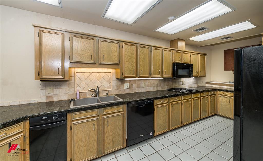 300 Pierremont Road, Unit 40 Shreveport, LA 71106 - Photo 13 of 34 Kitchen featuring extensive cabinetry, black countertops, a double basin sink, black appliances, and recessed ceiling lighting