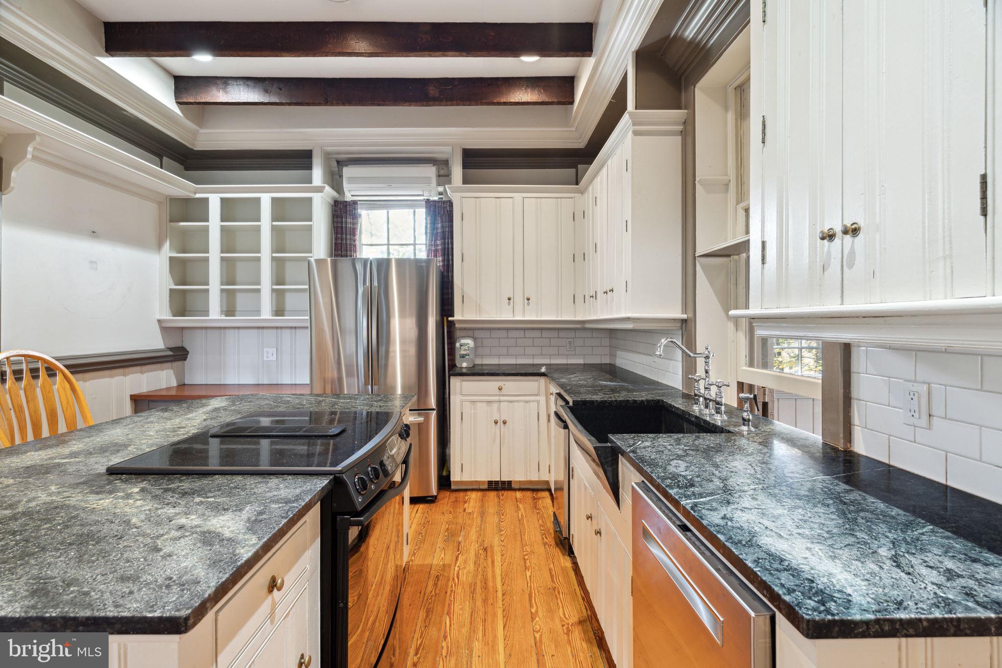 162 Sheehan Road Avondale, PA 19311 - Photo 19 of 83 a kitchen with granite countertop a sink a counter top space and stainless steel appliances