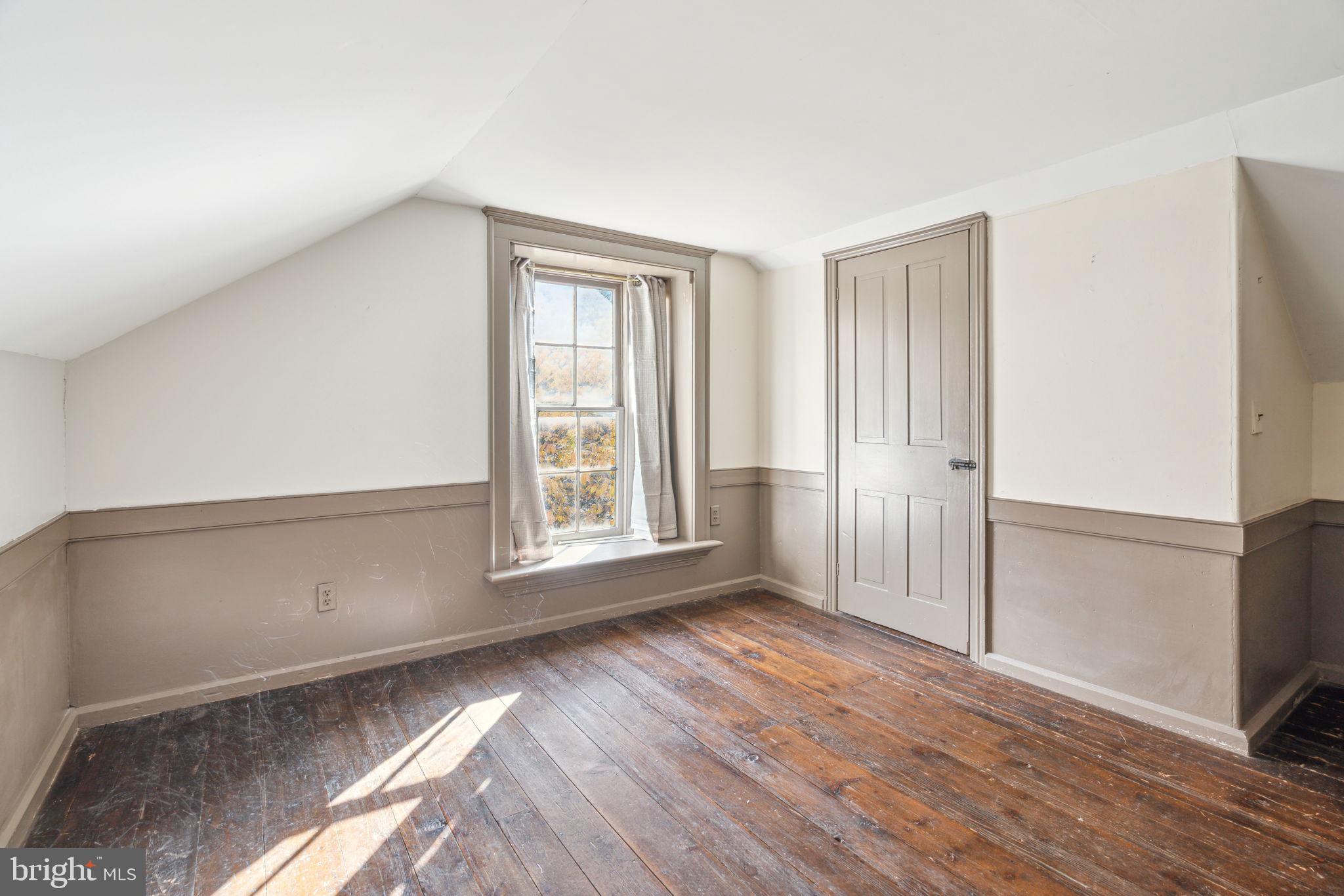 162 Sheehan Road Avondale, PA 19311 - Photo 47 of 83 a view of an empty room with wooden floor and a window