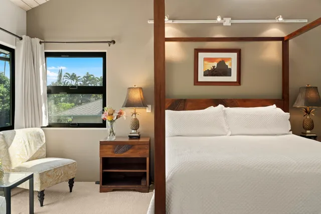 a bedroom with a bed and a painting on the wall