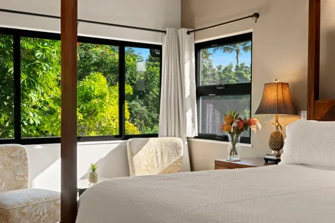 a bedroom with a bed and a large window