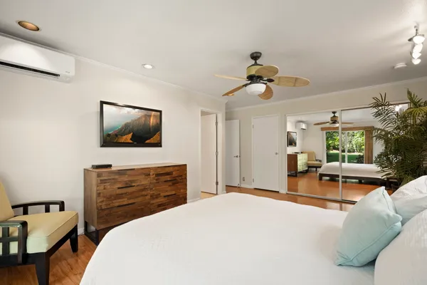 a bedroom with a bed and a flat screen tv