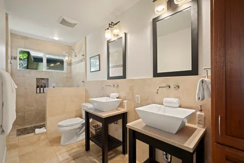 a bathroom with a toilet a sink and a mirror
