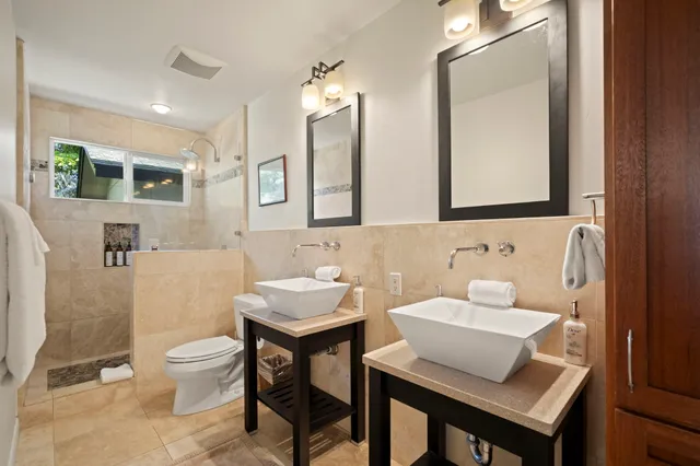 a bathroom with a toilet a sink and a mirror