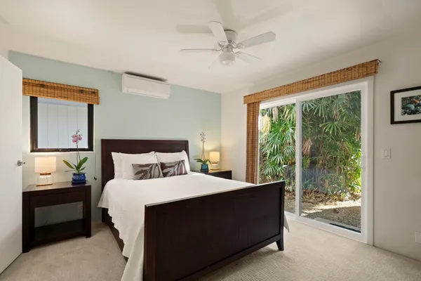 a bedroom with a bed and large window