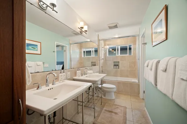 a spacious bathroom with a sink mirror and a bathtub