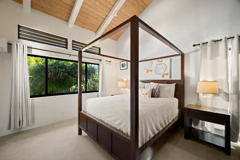 a bedroom with a bed and a balcony