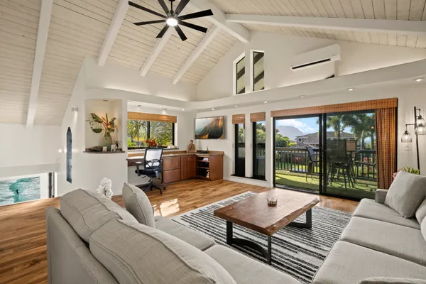 a living room with furniture ceiling fan and a rug