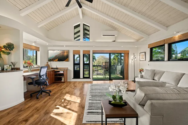 a living room with furniture a fireplace and a floor to ceiling window