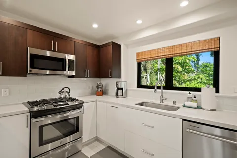 a kitchen with a sink stove and microwave