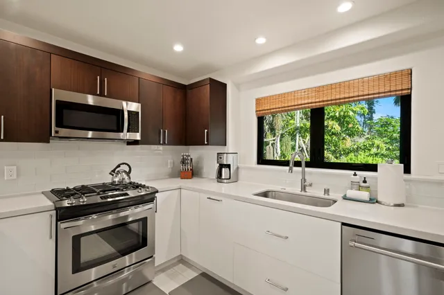 a kitchen with a sink stove and microwave