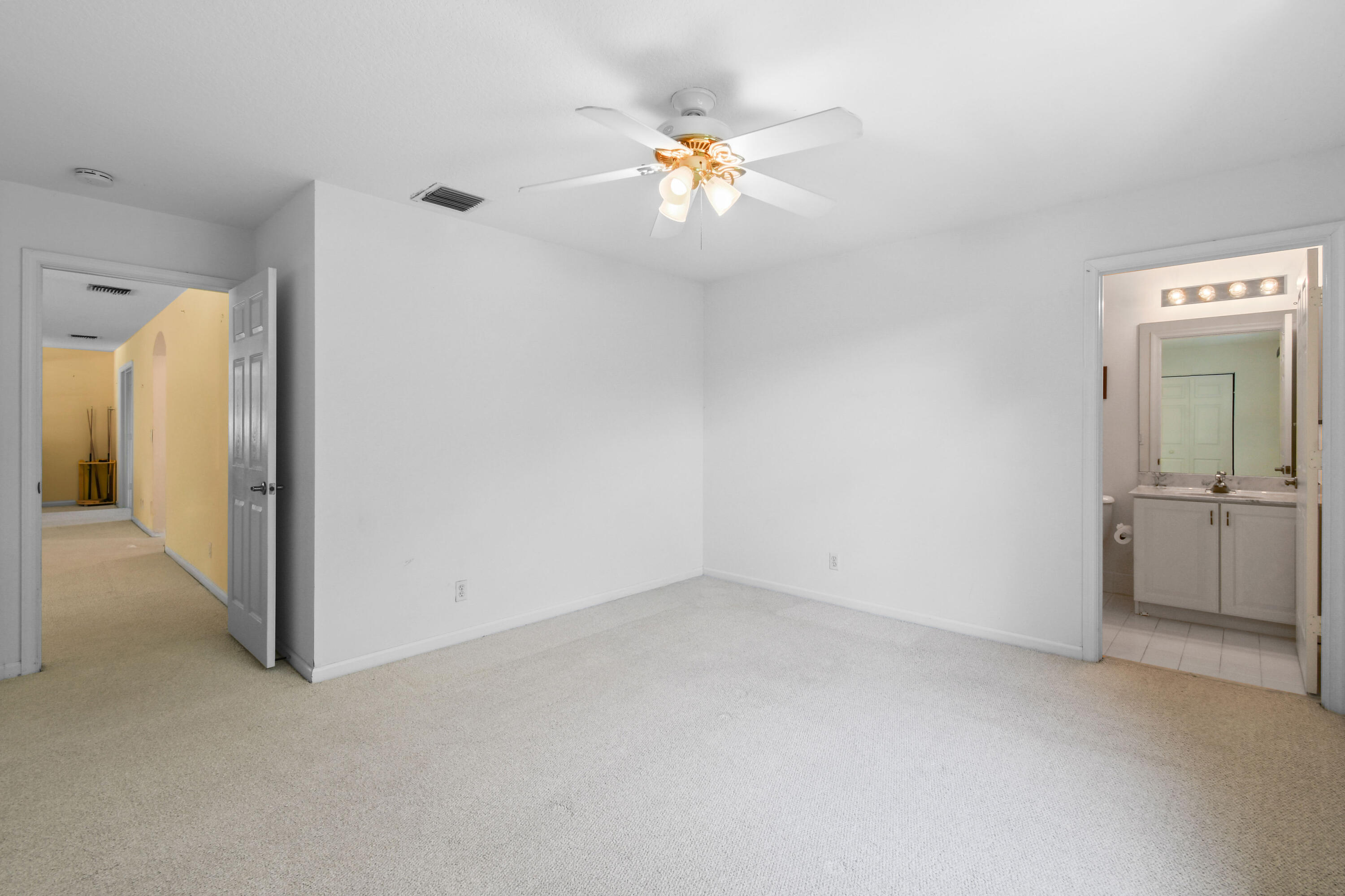 575 Scrubjay Lane Jupiter, FL 33458 - Photo 31 of 60 wooden floor in an empty room and a bathroom