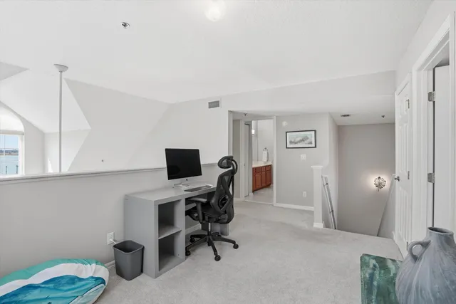 a bedroom with two beds and a chandelier