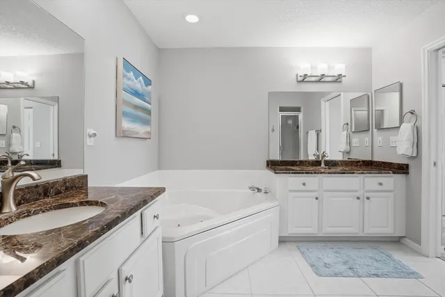 a bathroom with a glass shower door and a sink
